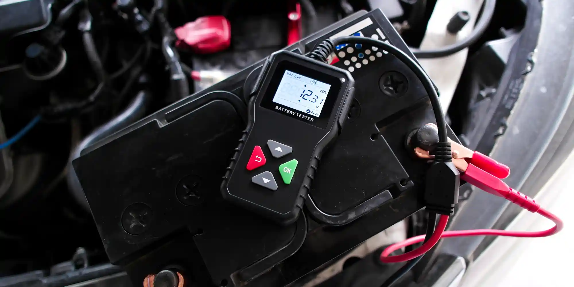 Car battery being tested with a battery tester