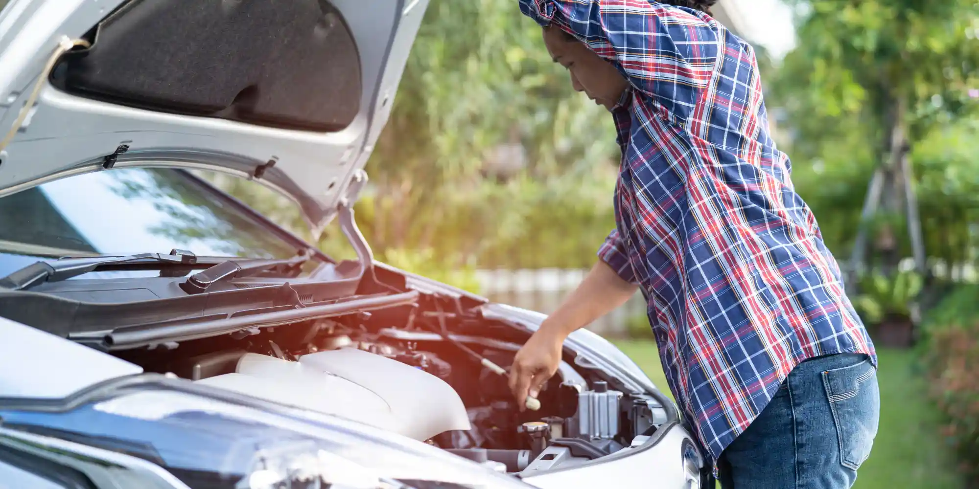 Driver checking car battery under the hood in Antipolo