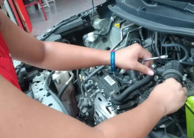 Technician replacing a green Amaron car battery during on-site service in Rizal.