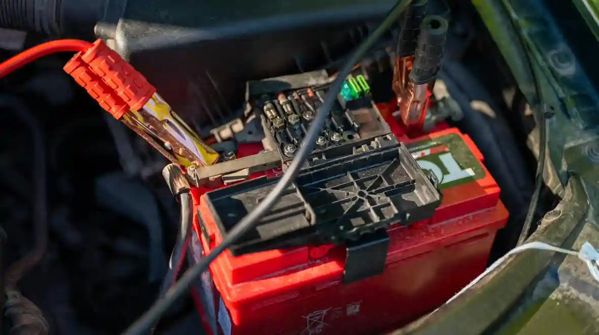 Car Battery with Jumper Cables in Engine Bay Car Battery with Jumper Cables in Engine Bay