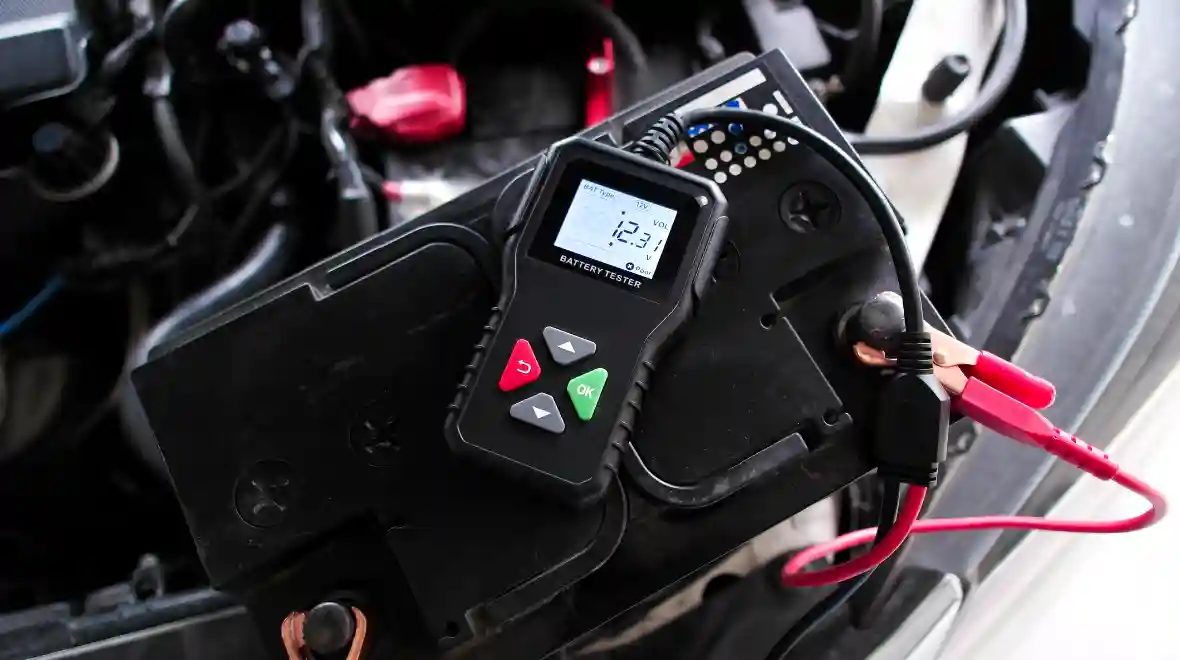 Car battery being tested with a battery tester