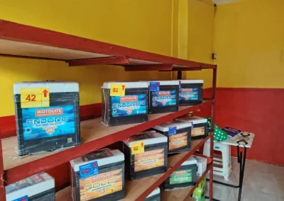 Motolite Enduro car batteries neatly arranged on red metal shelves inside Jet Battery Trading Rizal branch