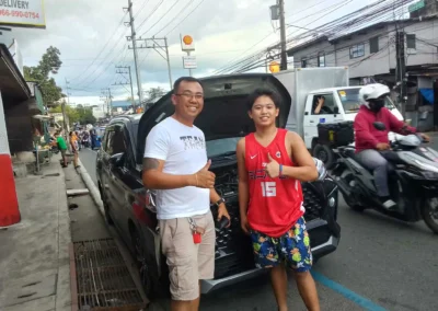 Happy Jet Battery Trading customers after successful car battery installation in Rizal.